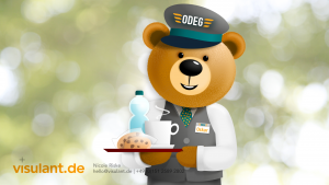 Maskottchen für die ODEG, Oskar trägt ein Tablett mit Keksen, heißem Kaffee und einer Wasserflasche